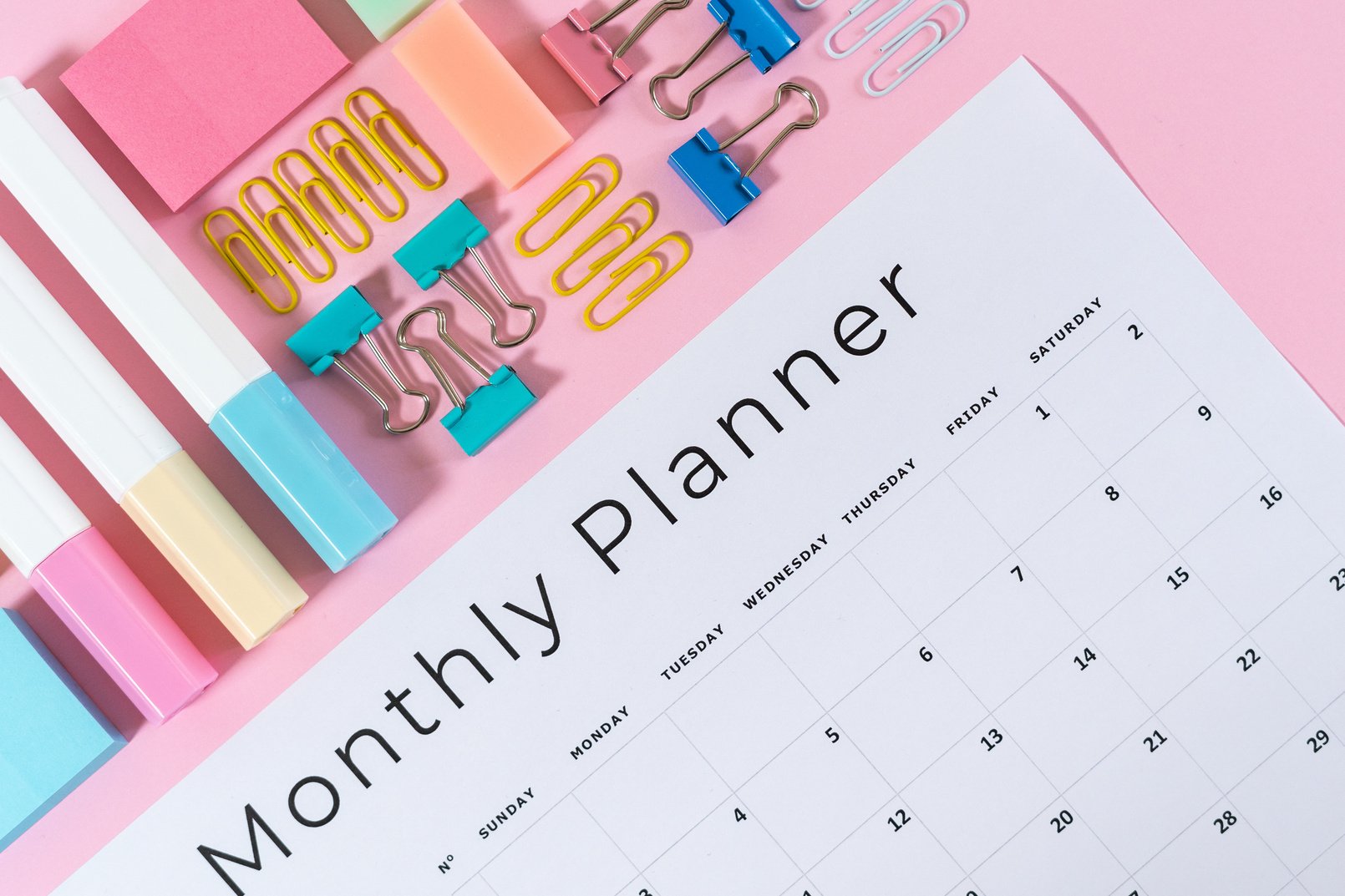 Stationery and planner on pink pastel background